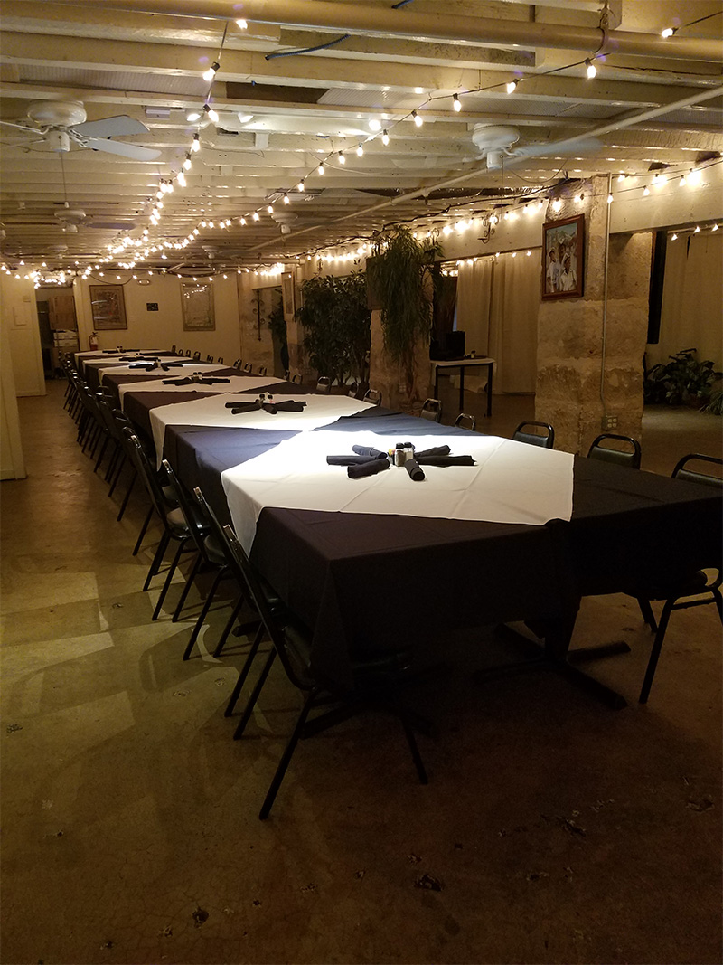 The Fiesta Room with long tables and warm lighting