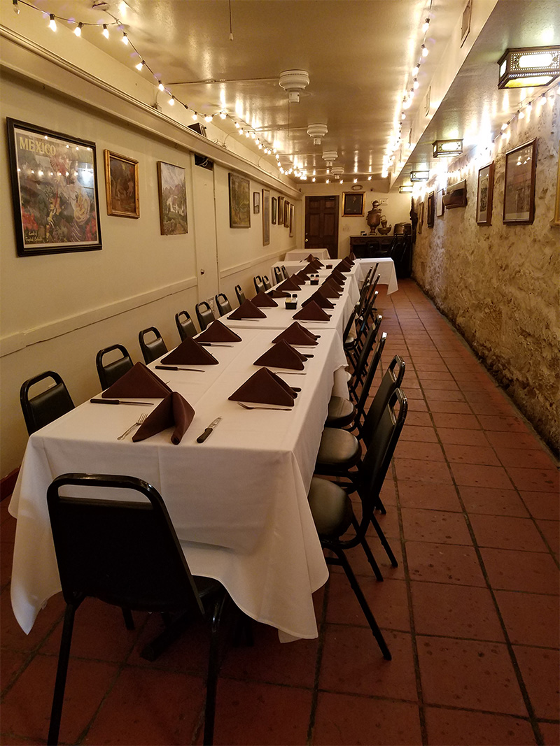 The Mission Room set with white linens and string lights